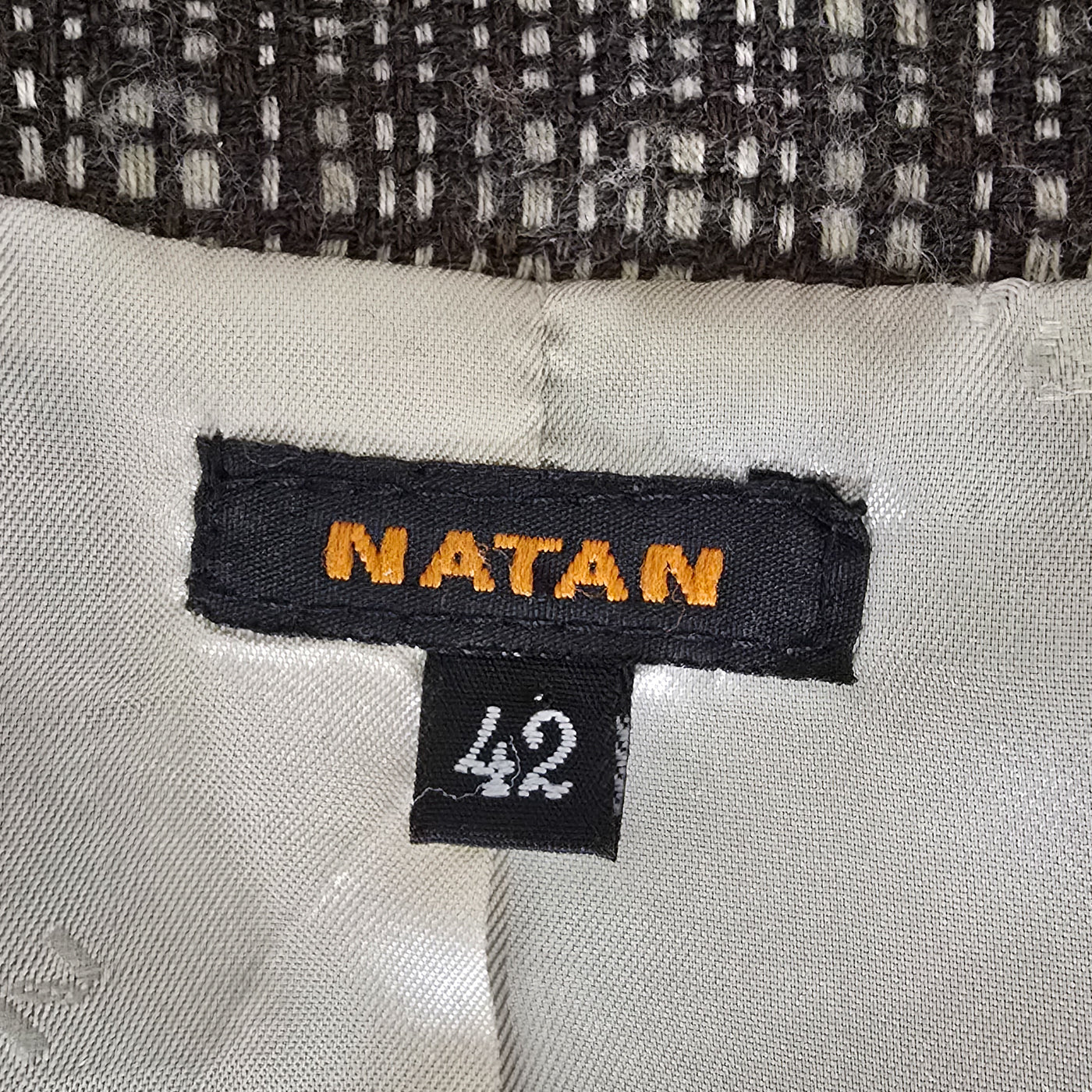 A brown checkered NATAN jacket, displaying a classic design suitable for both city and countryside wear.