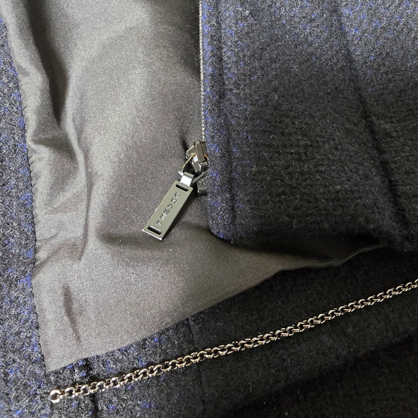 Vintage Chanel Cashmere Jacket in black and blue mixed cashmere blend with multiple front pockets, embossed zipper, and interlocking CC manchette detail.