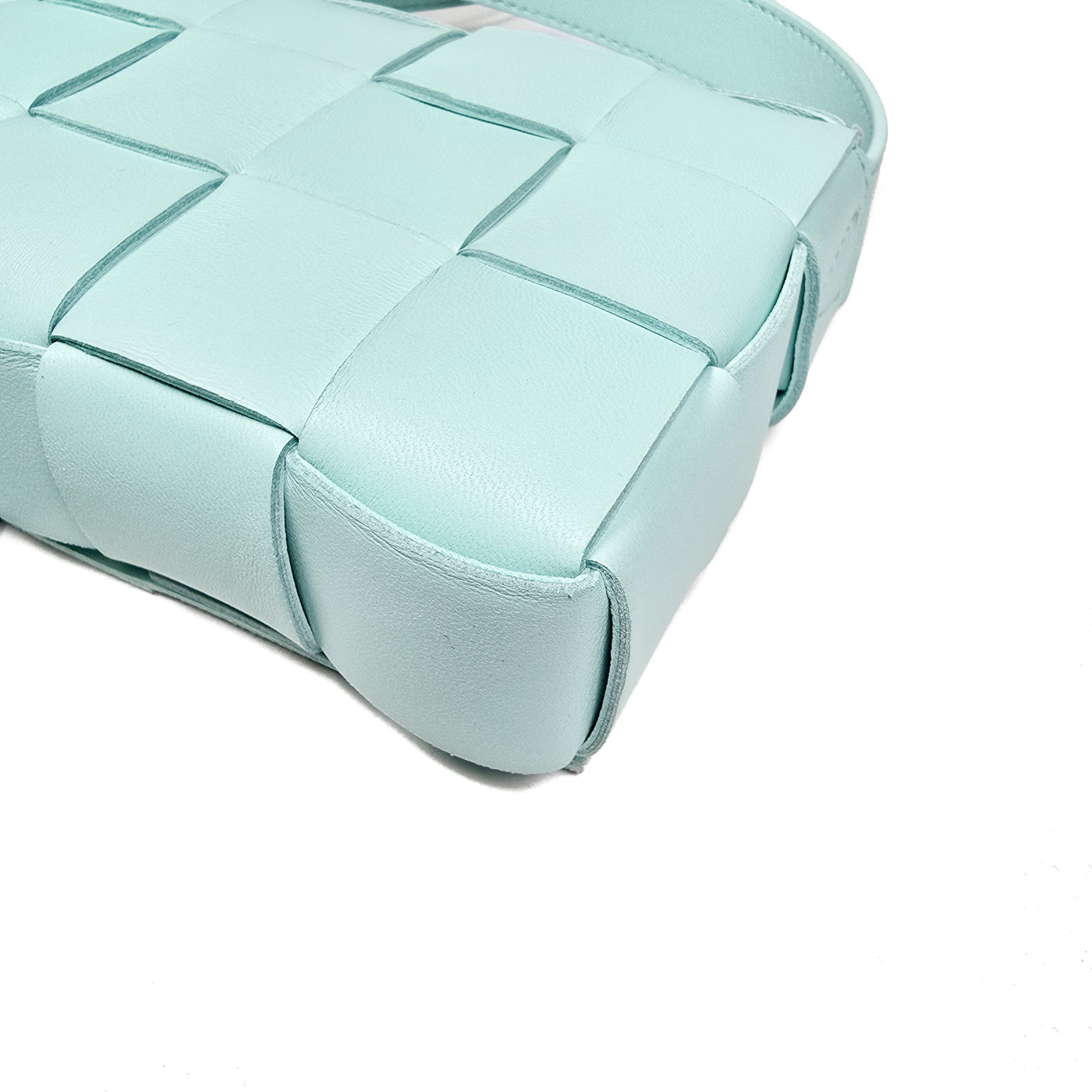 A Bottega Veneta lambskin leather crossbody bag in Tiffany blue with aged gold hardware accents, displayed against a white background.