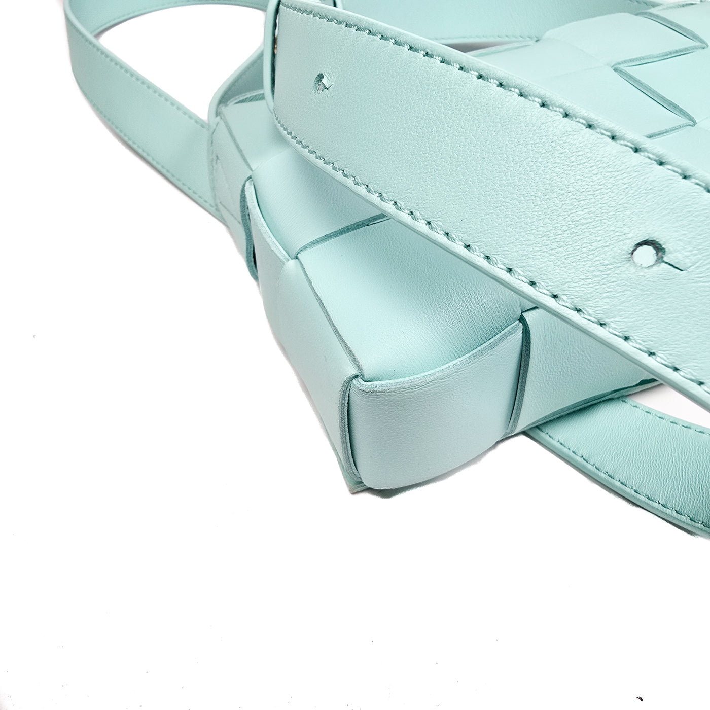 A Bottega Veneta lambskin leather crossbody bag in Tiffany blue with aged gold hardware accents, displayed against a white background.