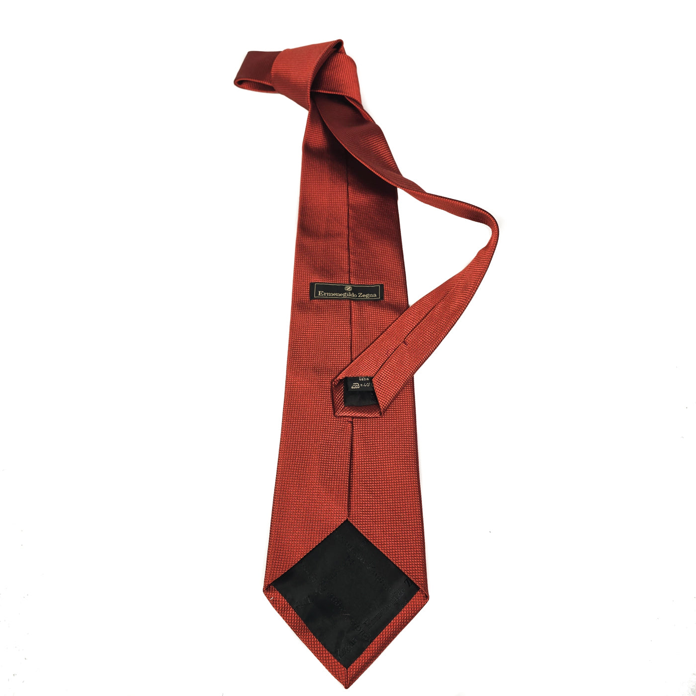 A red metallic textured silk tie by Ermenegildo Zegna, displayed in a straightforward manner against a white background.