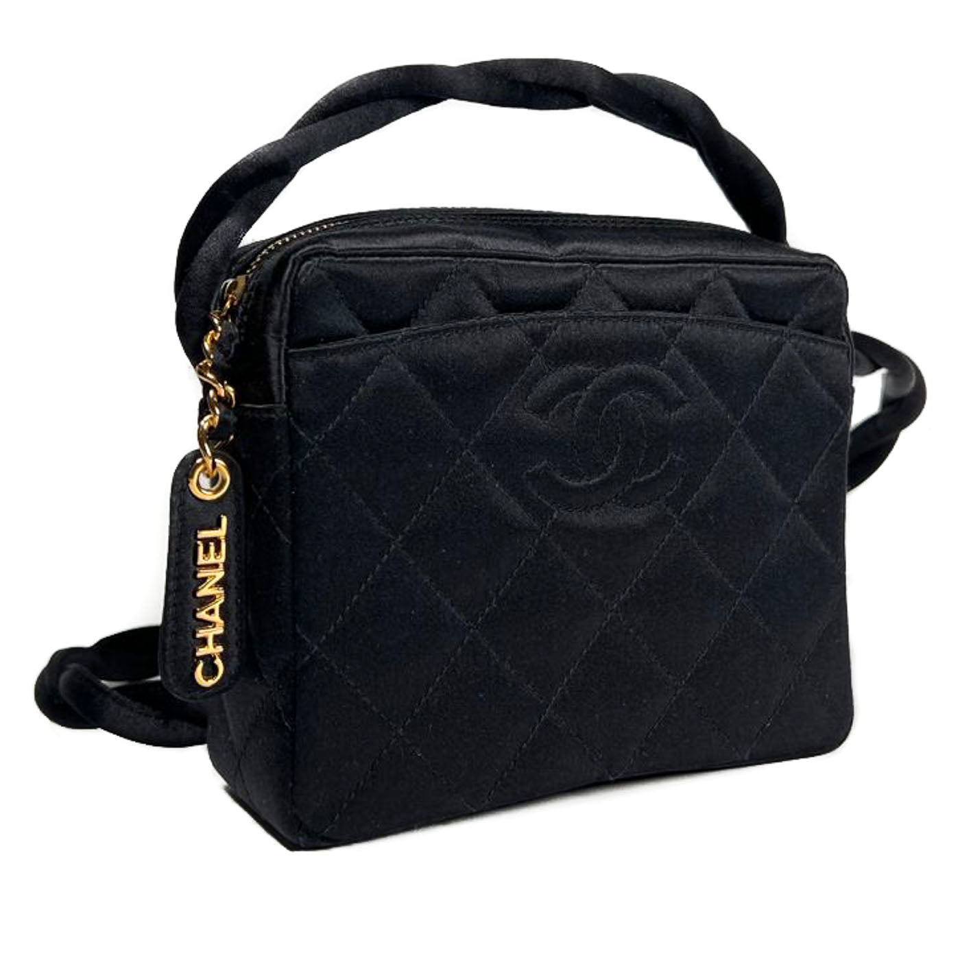 Vintage Chanel Black Quilted Satin CC Evening Bag 1996-1997.
A vintage Chanel black quilted satin evening bag with a twisted strap and gold-plated CHANEL lettering on the zipper pull.