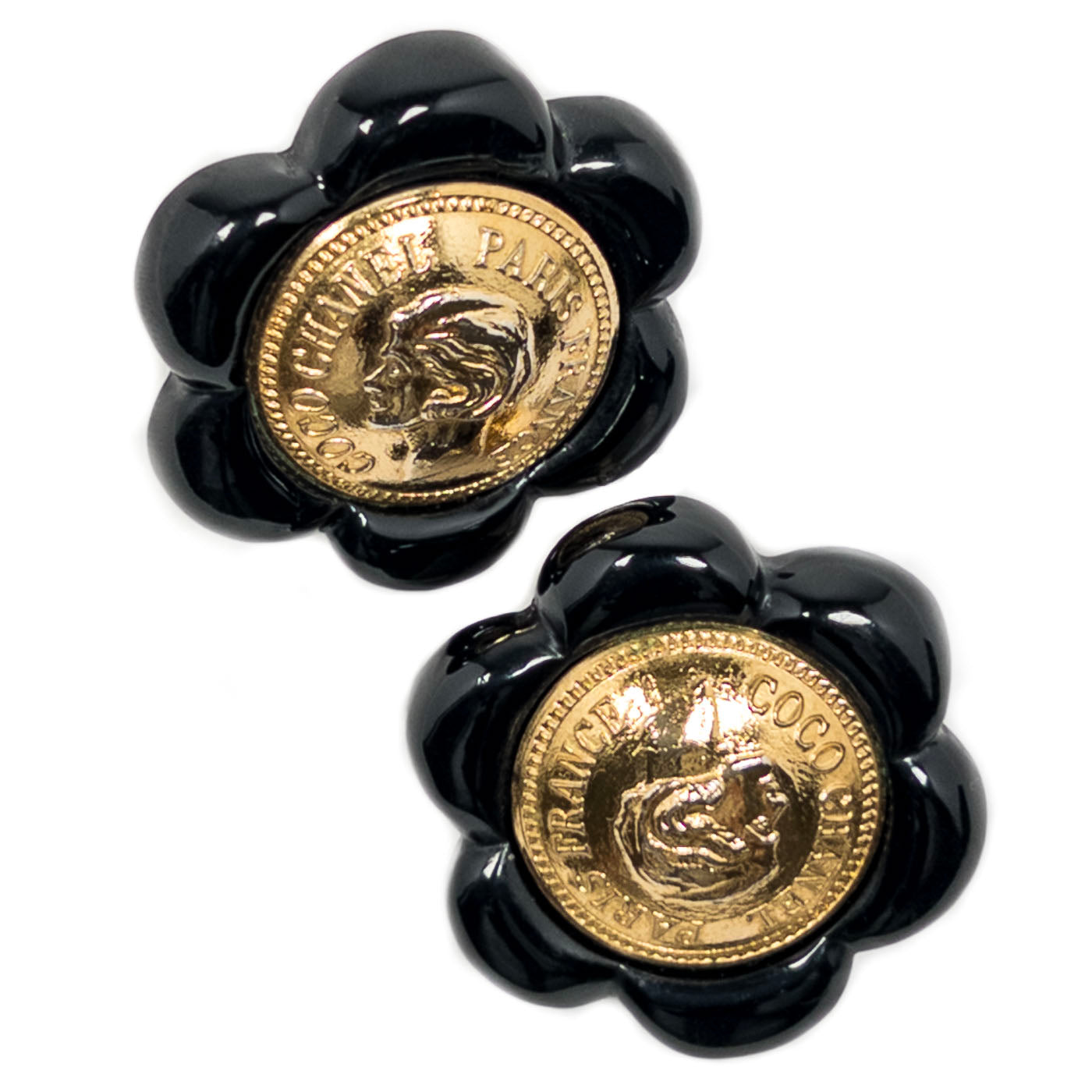 Vintage Chanel Earrings Black Camelia Coco Cameo Clip 1984
A pair of vintage Chanel black camellia clip earrings featuring a golden cameo design.