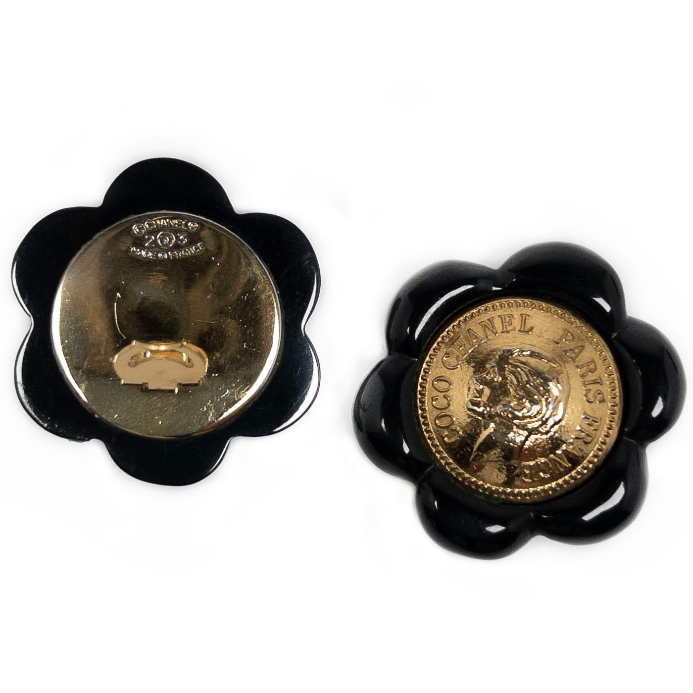Vintage Chanel Earrings Black Camelia Coco Cameo Clip 1984
A pair of vintage Chanel black camellia clip earrings featuring a golden cameo design.