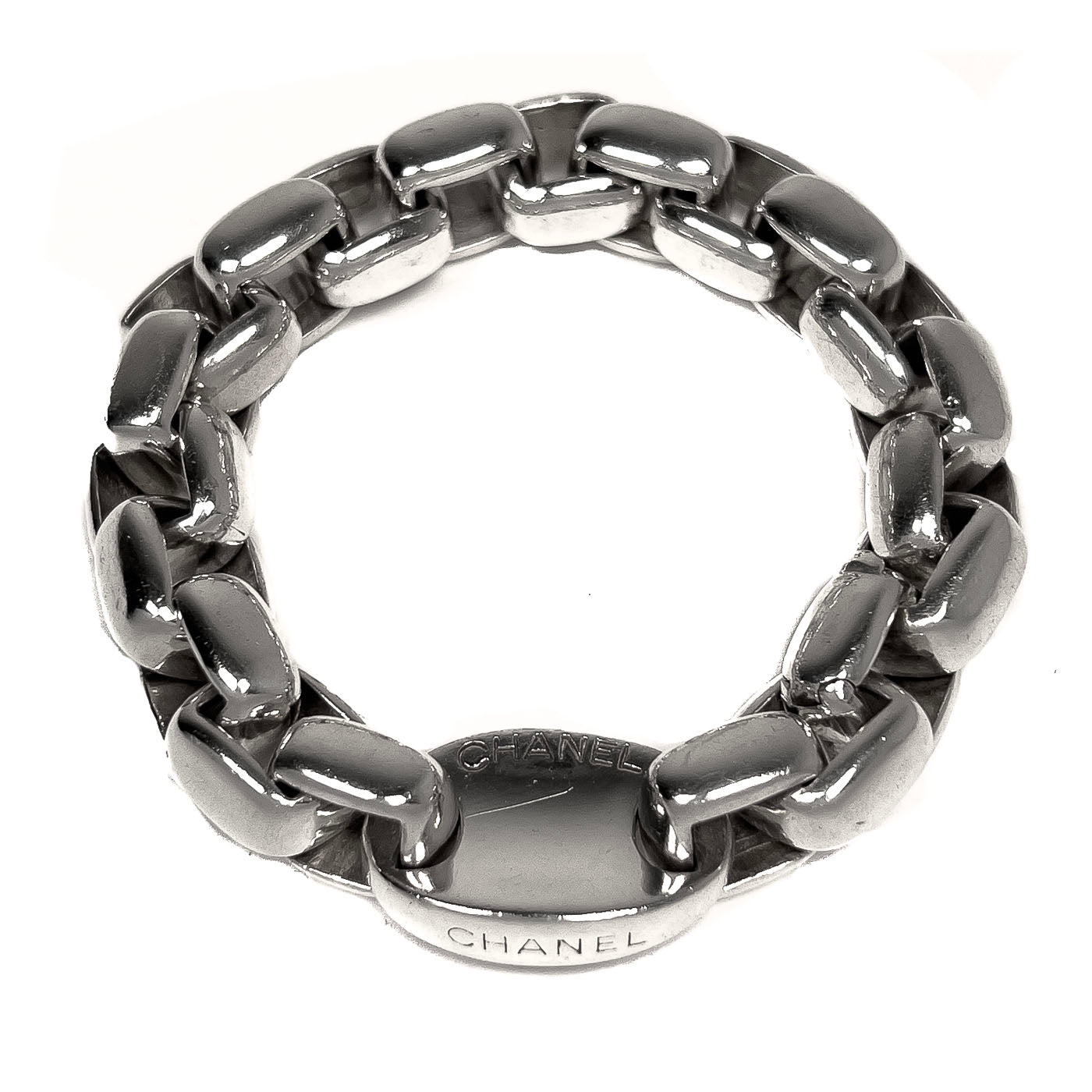 A vintage Chanel curb link sterling silver bracelet with the brand's logo on the clasp.
