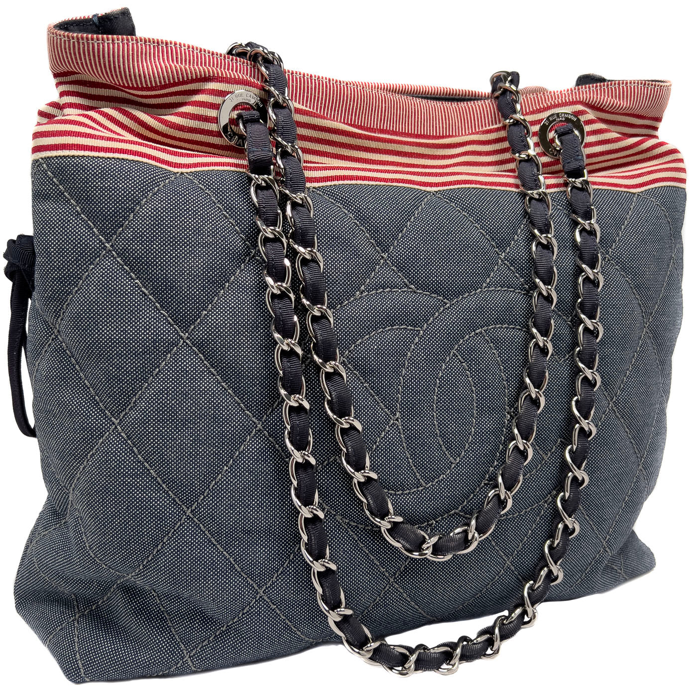 Pre-owned Chanel CC Tote Bag in blue denim with red and white striped accents, silver-tone hardware, drawstring and magnetic button closure.