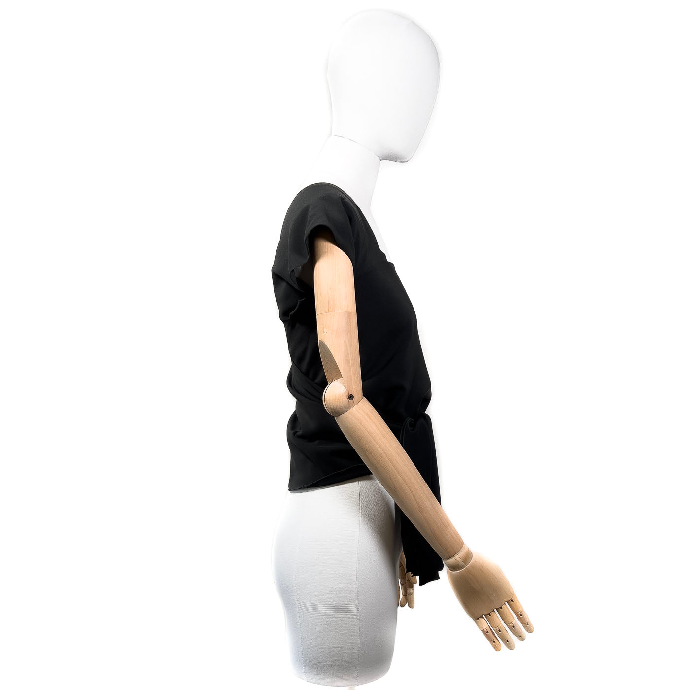 Pre-owned Chanel Boutique black wrap-around top displayed on a mannequin, featuring a wrap-around design with a tie at the waist.