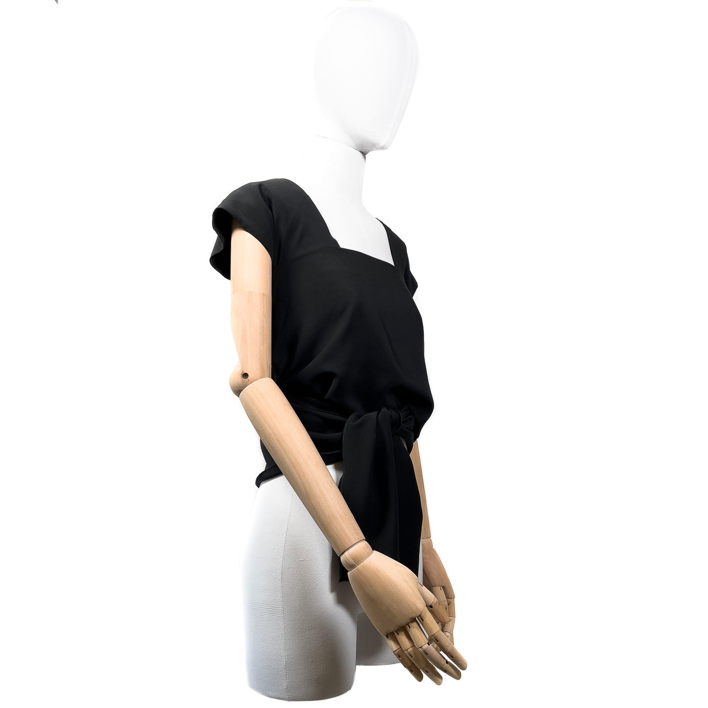 Pre-owned Chanel Boutique black wrap-around top displayed on a mannequin, featuring a wrap-around design with a tie at the waist.