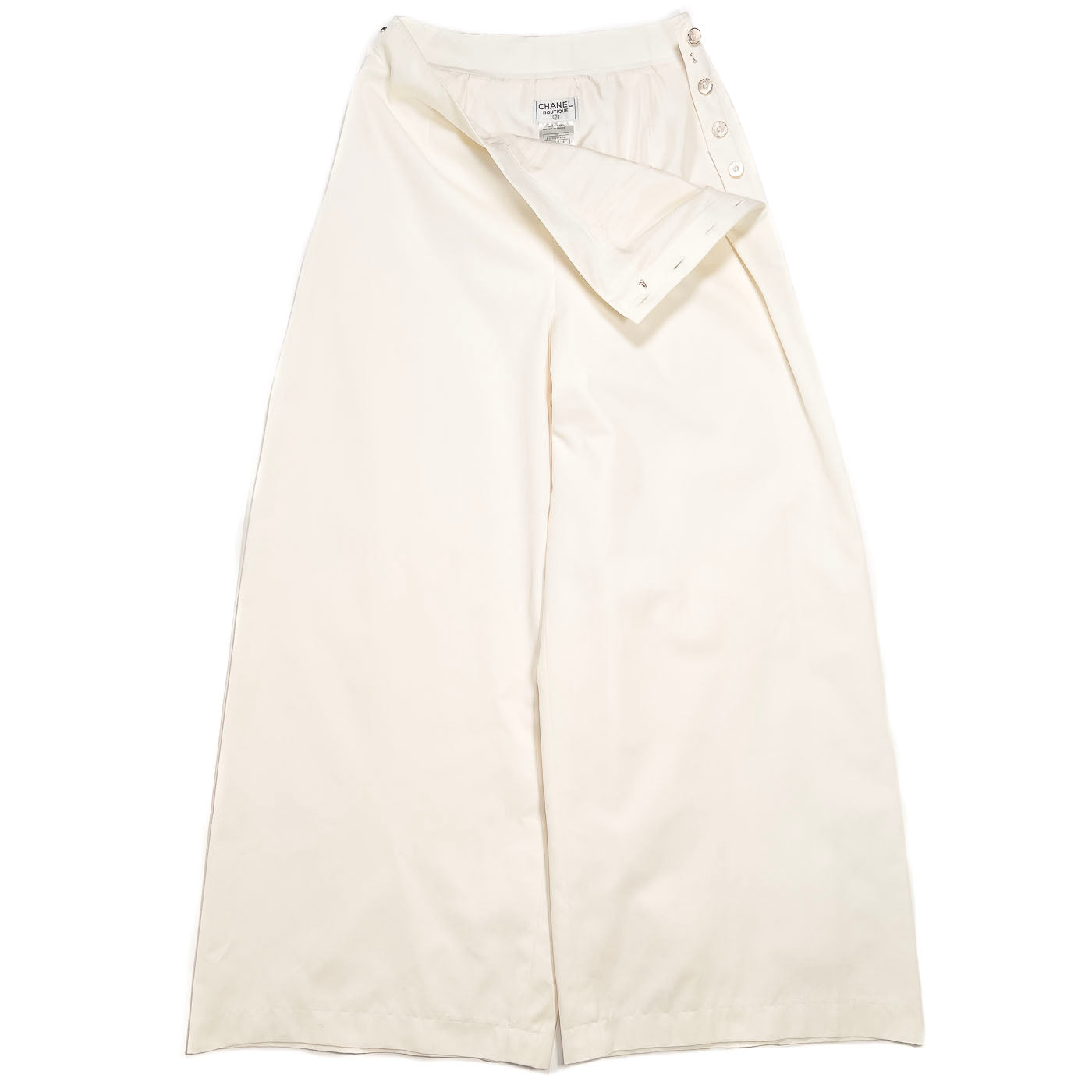 A pair of vintage Chanel Boutique ivory white trousers with button accents, displayed on a plain background.