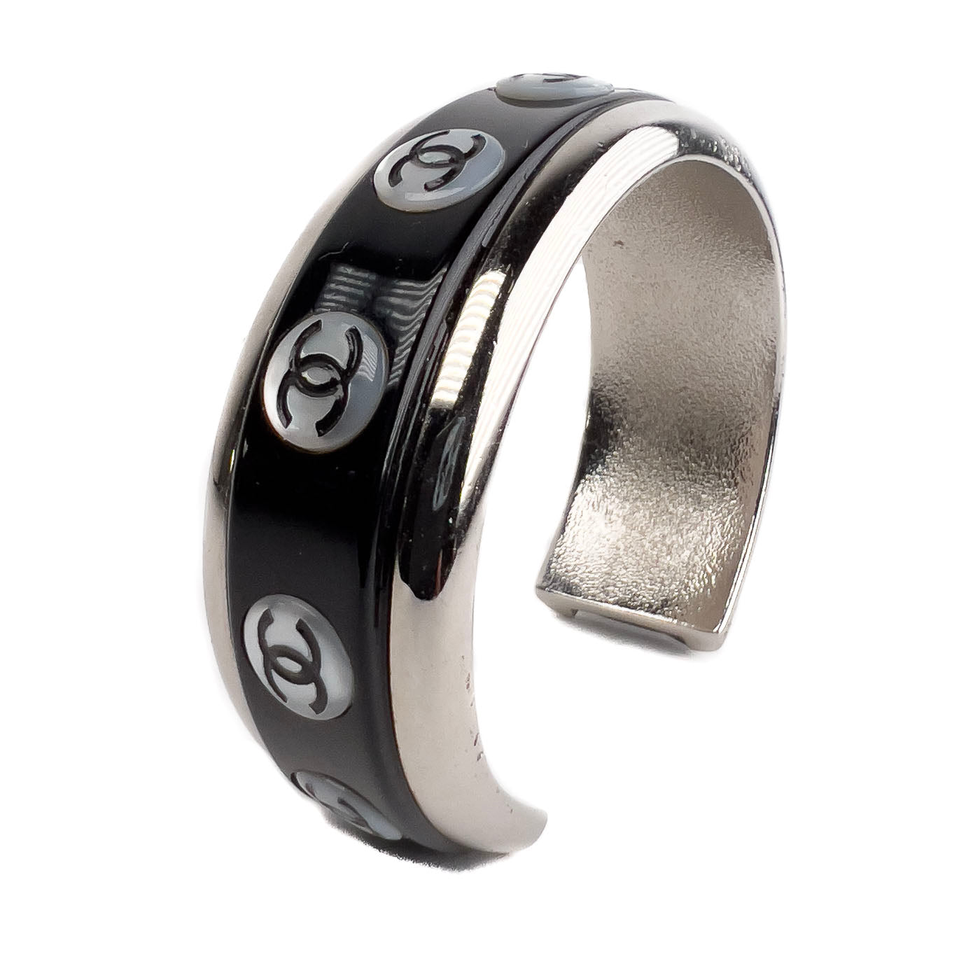 A vintage Chanel Mother of Pearl CC Cuff bracelet in silver tone with black lacquer and mother of pearl pastille CC inlays.