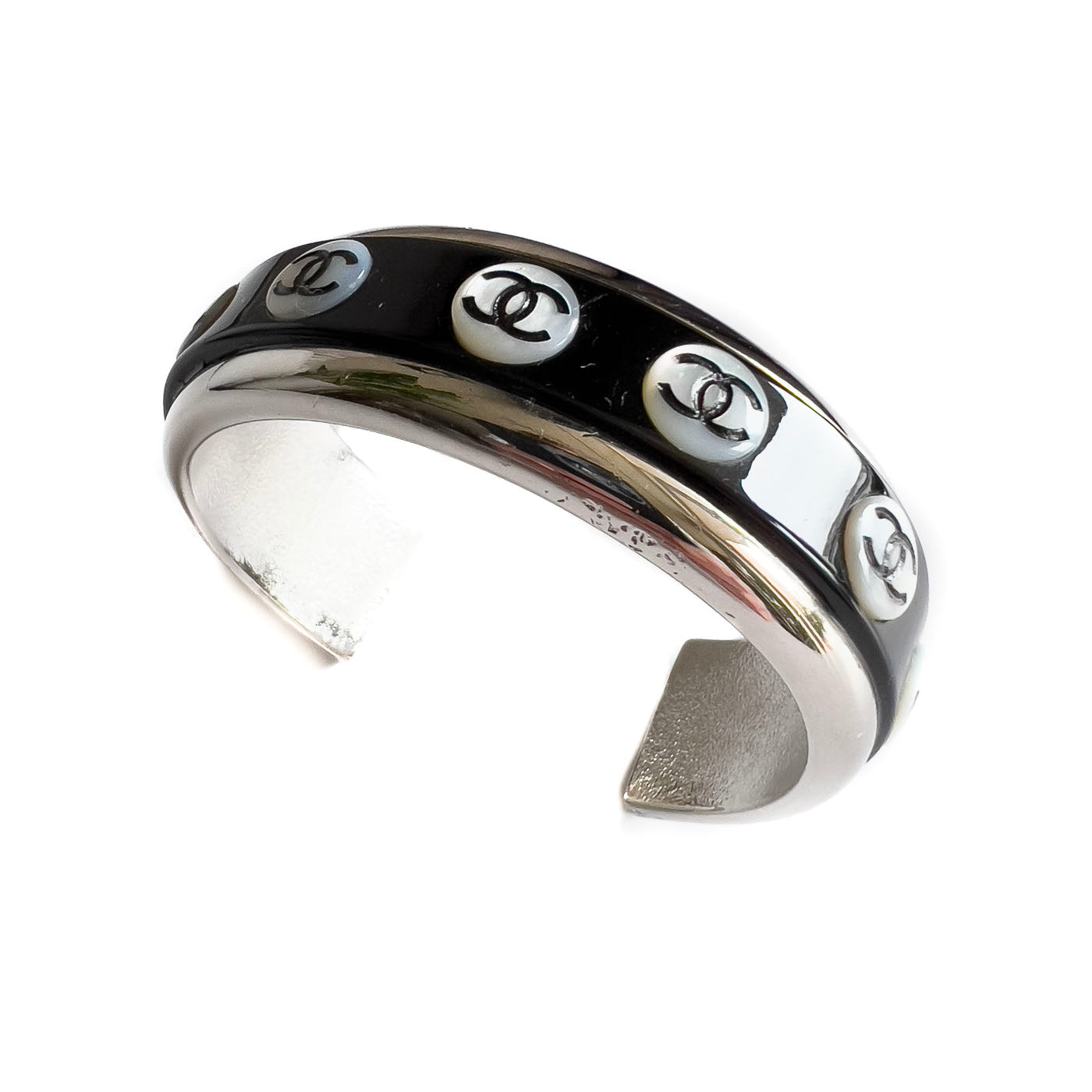 A vintage Chanel Mother of Pearl CC Cuff bracelet in silver tone with black lacquer and mother of pearl pastille CC inlays.