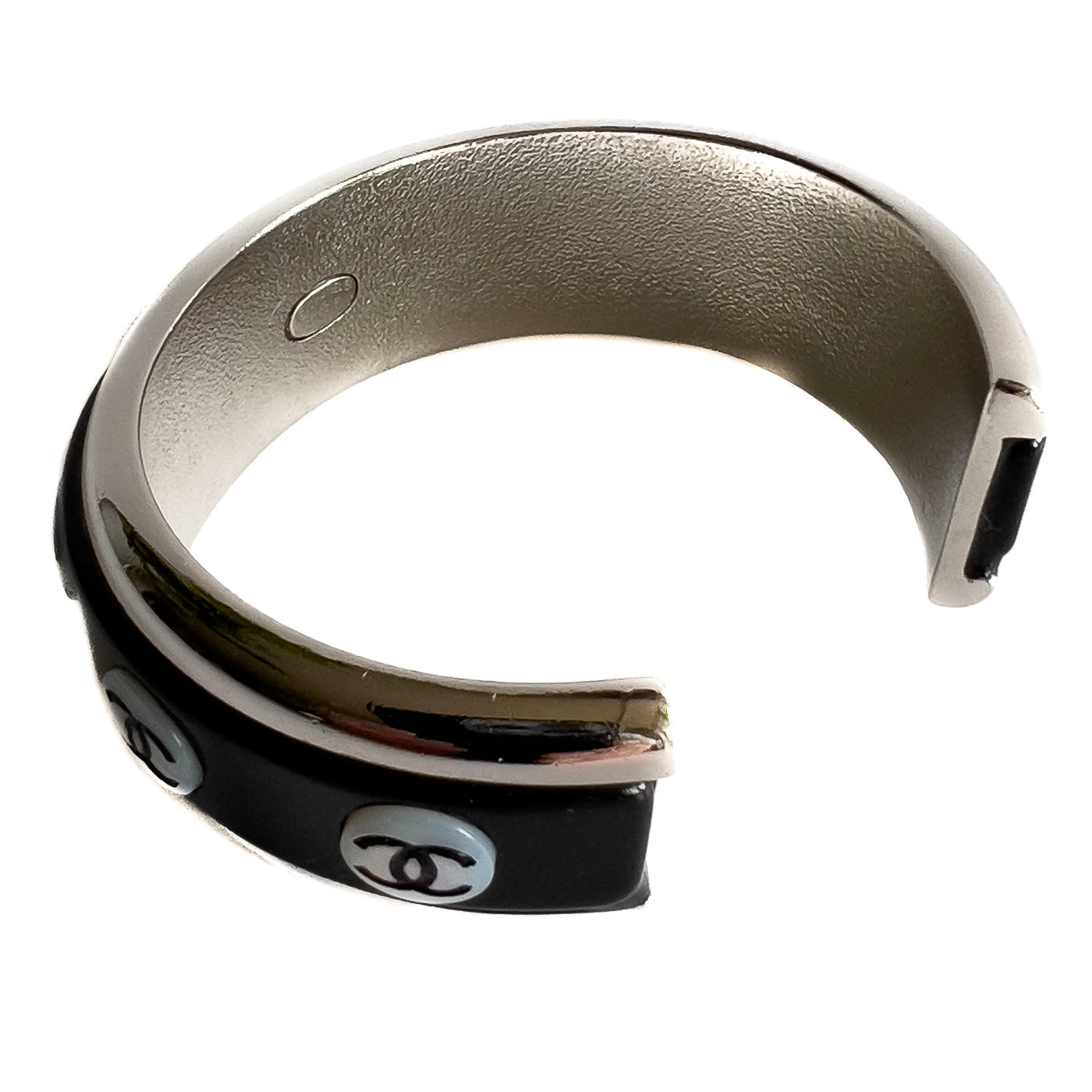 A vintage Chanel Mother of Pearl CC Cuff bracelet in silver tone with black lacquer and mother of pearl pastille CC inlays.