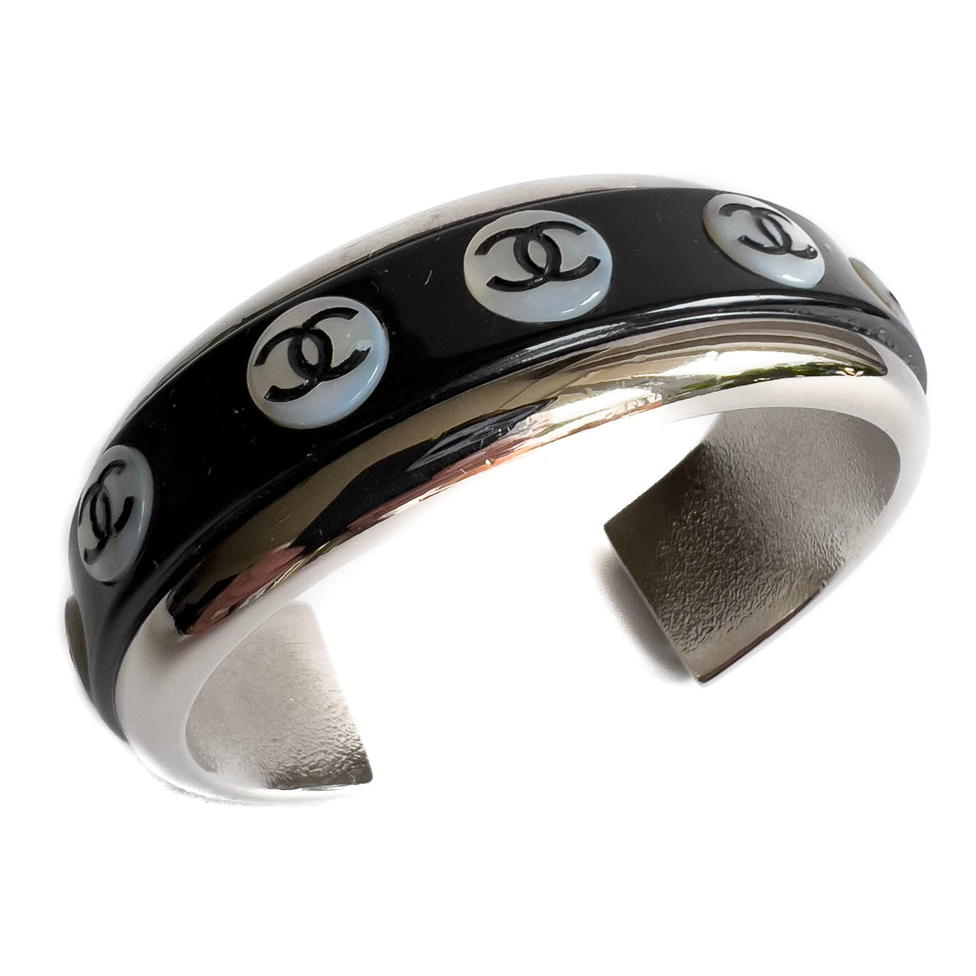 A vintage Chanel Mother of Pearl CC Cuff bracelet in silver tone with black lacquer and mother of pearl pastille CC inlays.