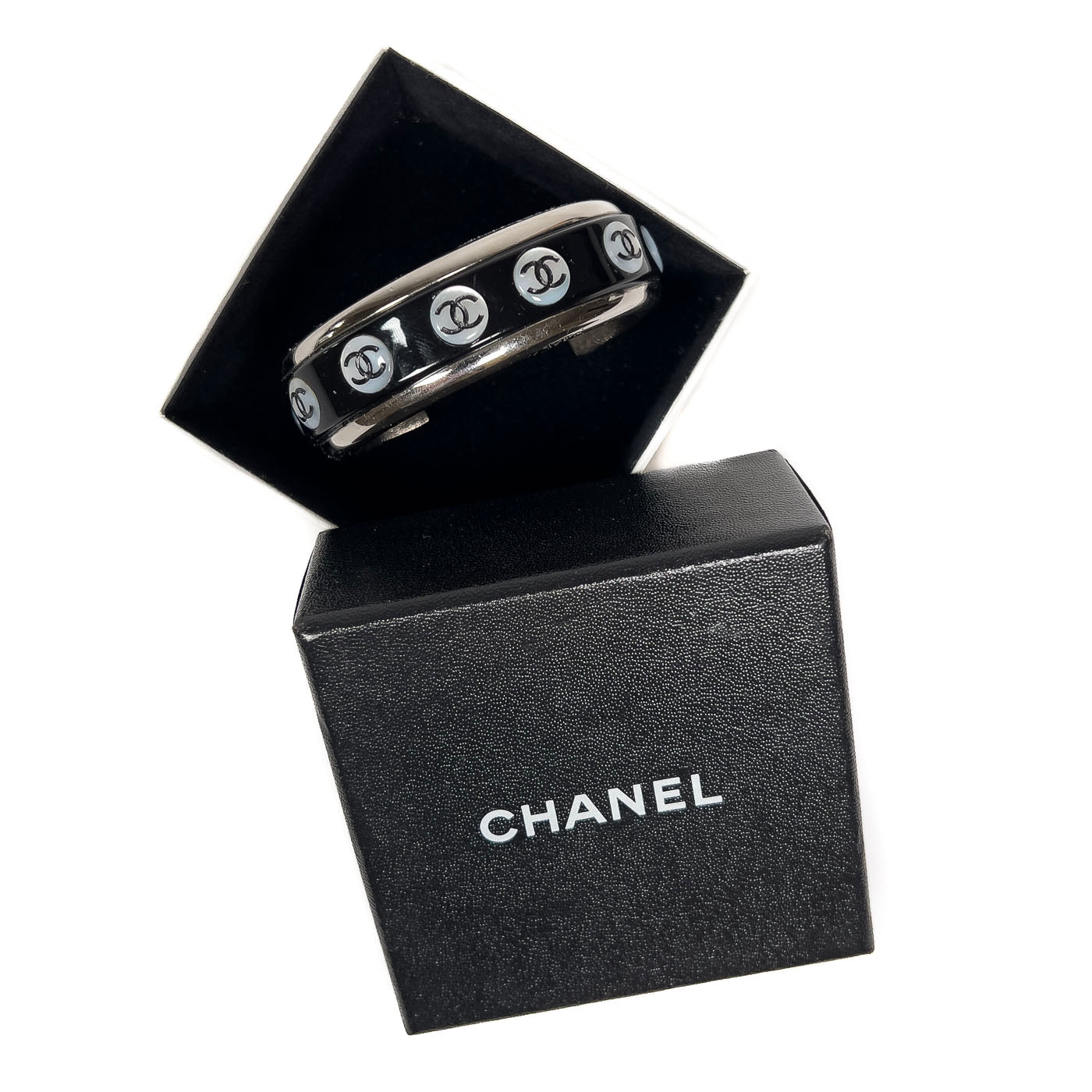 A vintage Chanel Mother of Pearl CC Cuff bracelet in silver tone with black lacquer and mother of pearl pastille CC inlays.