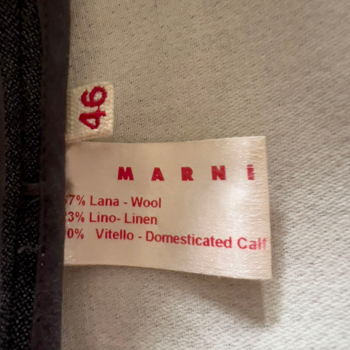 A Marni grey 3/4 sleeved coat with a calf leather belt, displayed on a mannequin with the belt detached and visible.