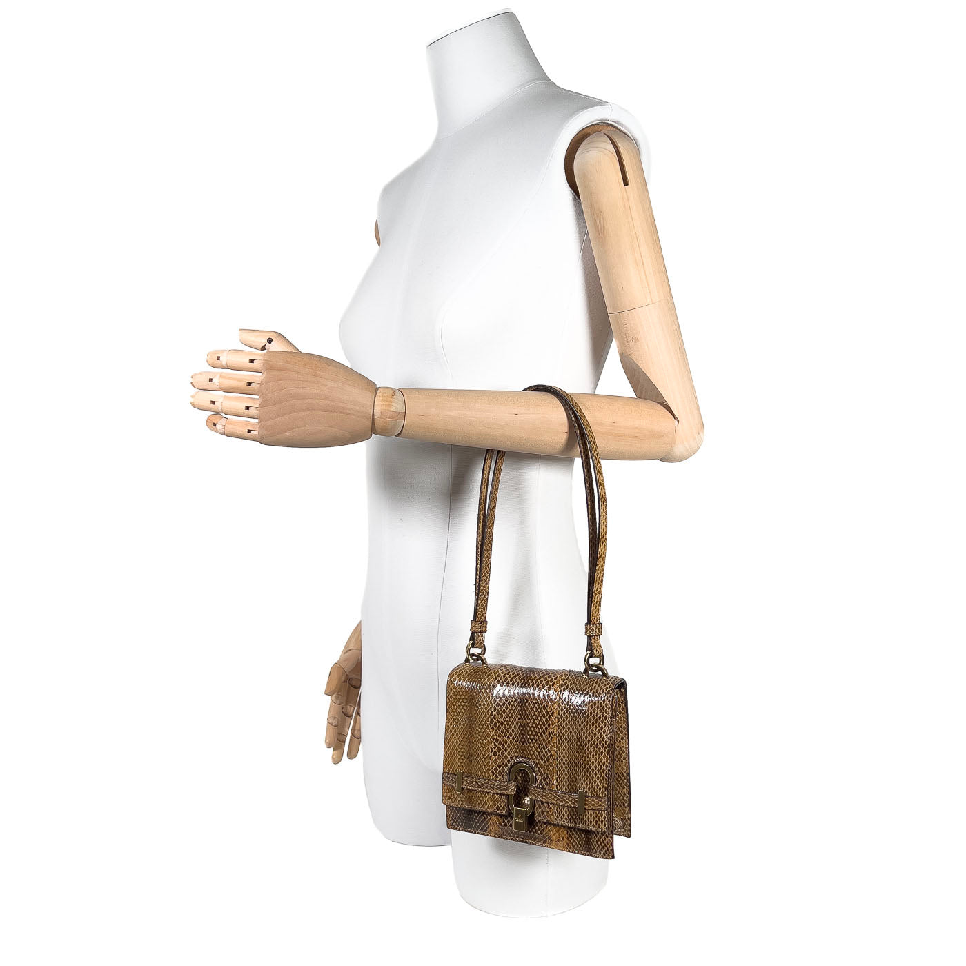A vintage Gucci python small handbag in cognac color, displayed on a mannequin, with gold plated hardware.