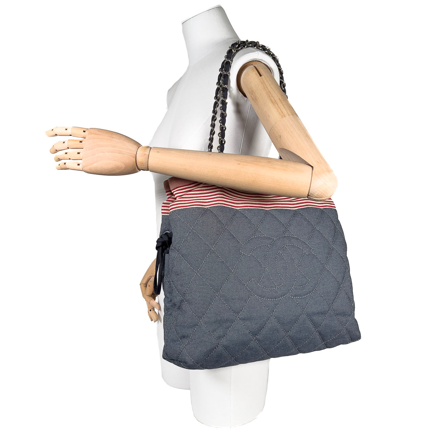 Pre-owned Chanel CC Tote Bag in blue denim with red and white striped accents, silver-tone hardware, drawstring and magnetic button closure.