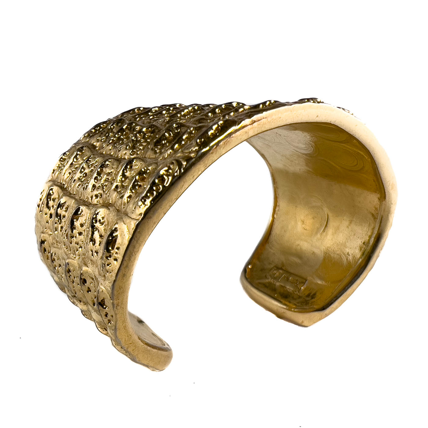 Vintage Yves Saint Laurent YSL Crocodile Pattern Cuff Bracelet Gold Tone. This beauty exemplifies the opulent style characteristic of Yves Saint Laurent. This line of jewelry was designed by Robert Goossens in 1986, as part of a collection honoring the 20th anniversary of Yves Saint Laurent. Pieces from this collection were prominently worn on screen by Penelope Cruz, in the movie Loving Pablo (2017),