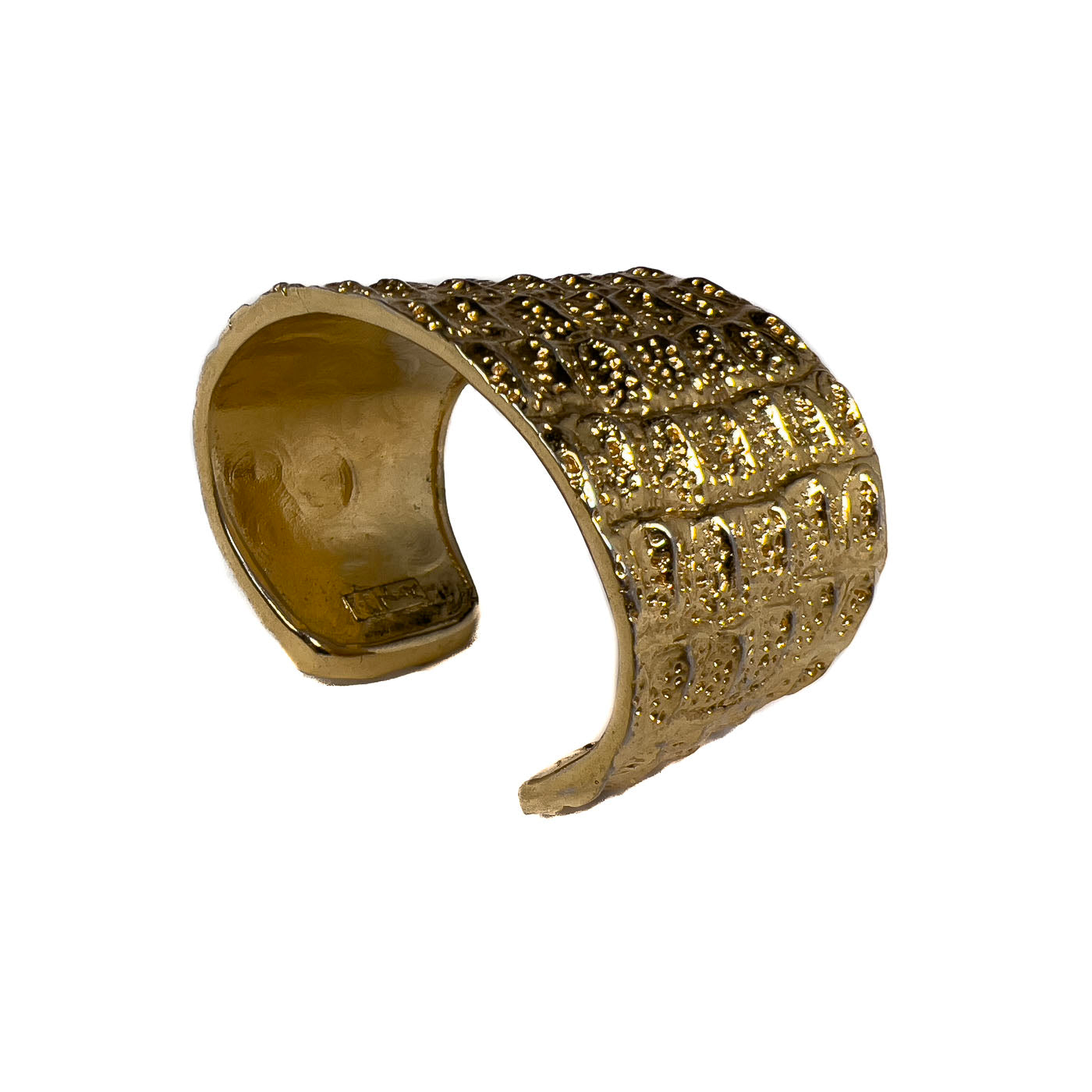 Vintage Yves Saint Laurent YSL Crocodile Pattern Cuff Bracelet Gold Tone. This beauty exemplifies the opulent style characteristic of Yves Saint Laurent. This line of jewelry was designed by Robert Goossens in 1986, as part of a collection honoring the 20th anniversary of Yves Saint Laurent. Pieces from this collection were prominently worn on screen by Penelope Cruz, in the movie Loving Pablo (2017).
