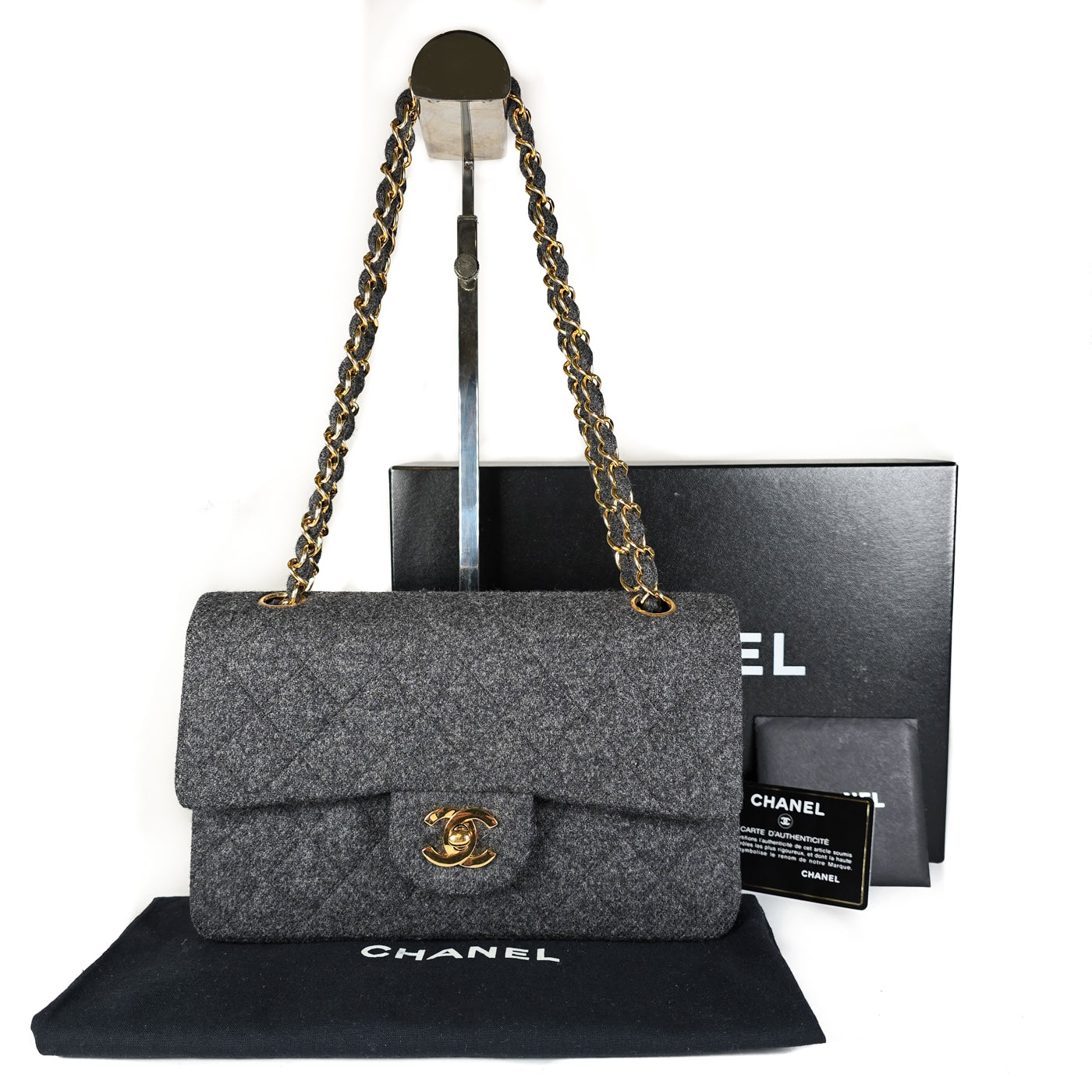 Chanel Vintage Grey Flannel Wool Double Flap Bag 24GHW Small 1990's.

A Chanel vintage grey flannel wool double flap handbag with gold plated chain and turn-lock hardware, accompanied by its original box and a dust bag.