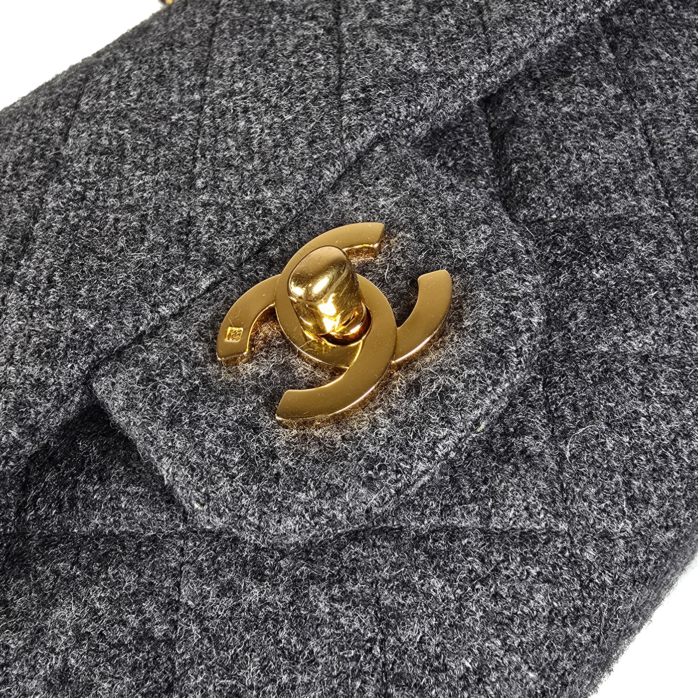A Chanel vintage grey flannel wool double flap handbag with gold plated chain and turn-lock hardware.