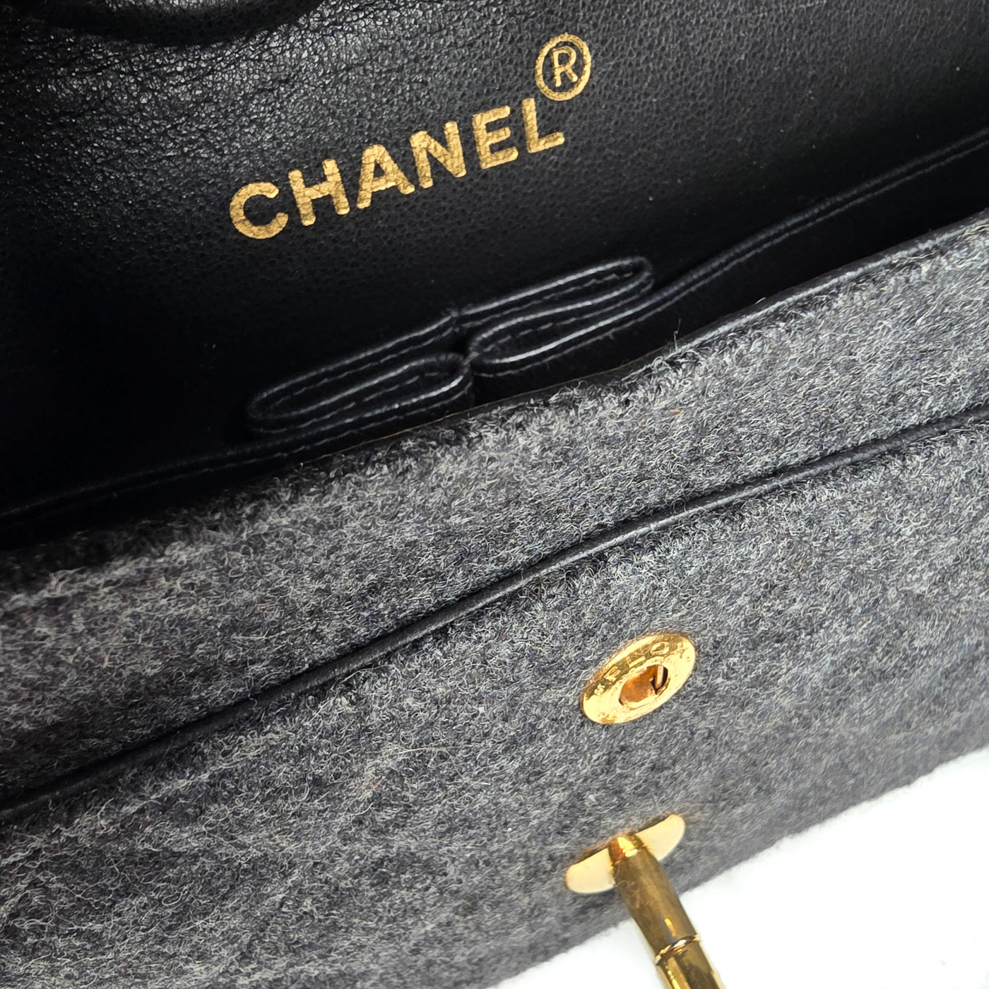 A Chanel vintage grey flannel wool double flap handbag with gold plated chain and turn-lock hardware.