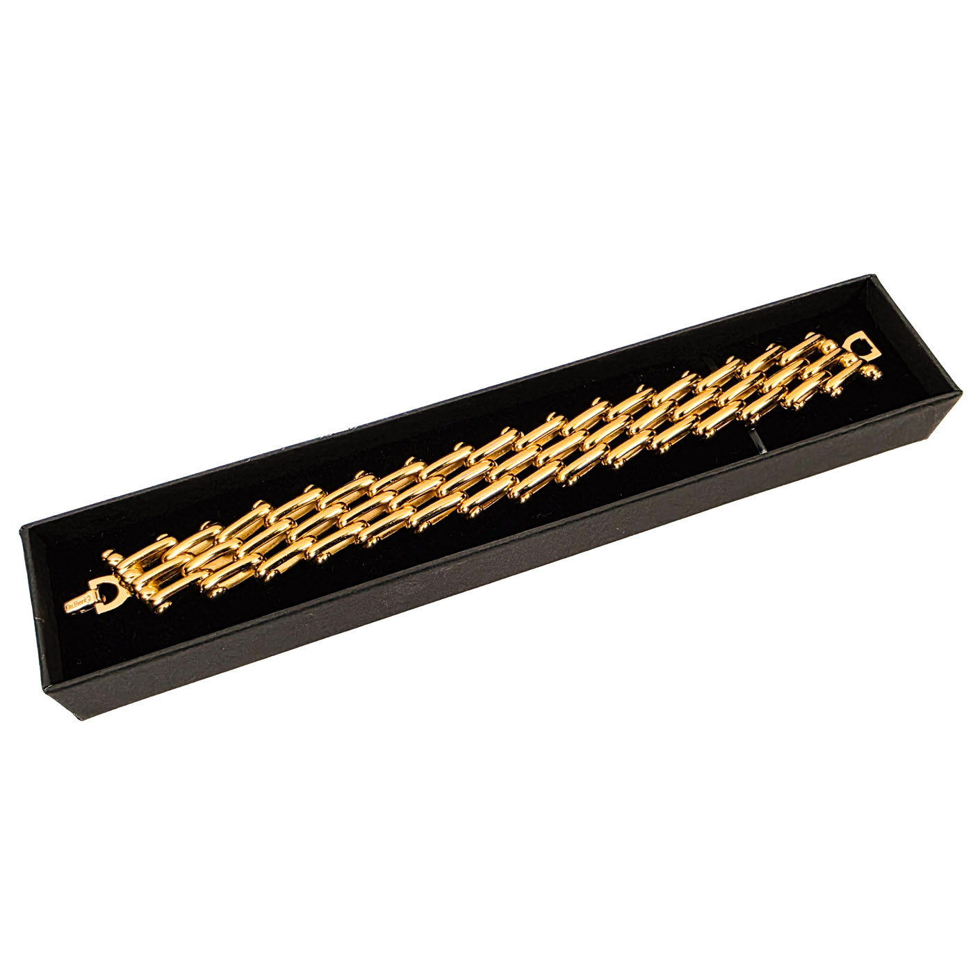 Golden Vintage Christian Dior bracelet in a black display box on a white background